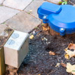 a blue fire hydrant sitting on top of a sidewalk