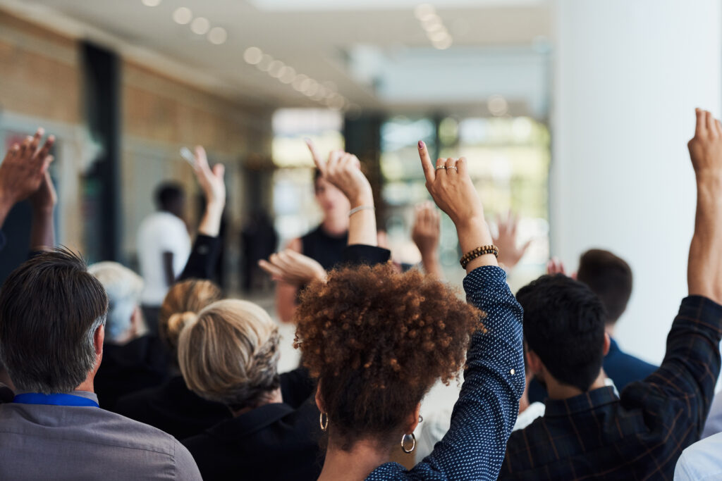 a group of people raising their hands in the air