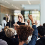 a group of people raising their hands in the air